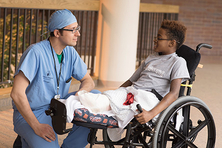 physician and patient in wheelchair