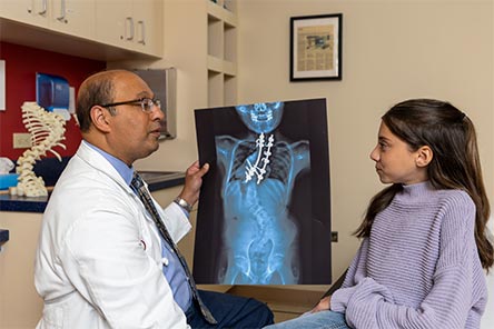 A patient and doctor looking at her x-ray