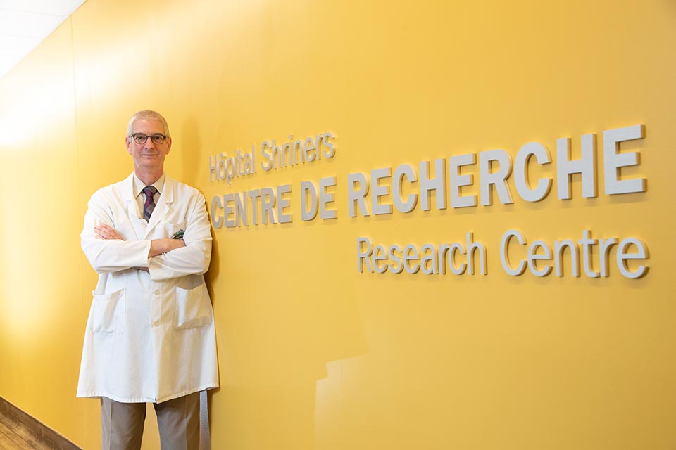 Doctor standing by the Research Center sign