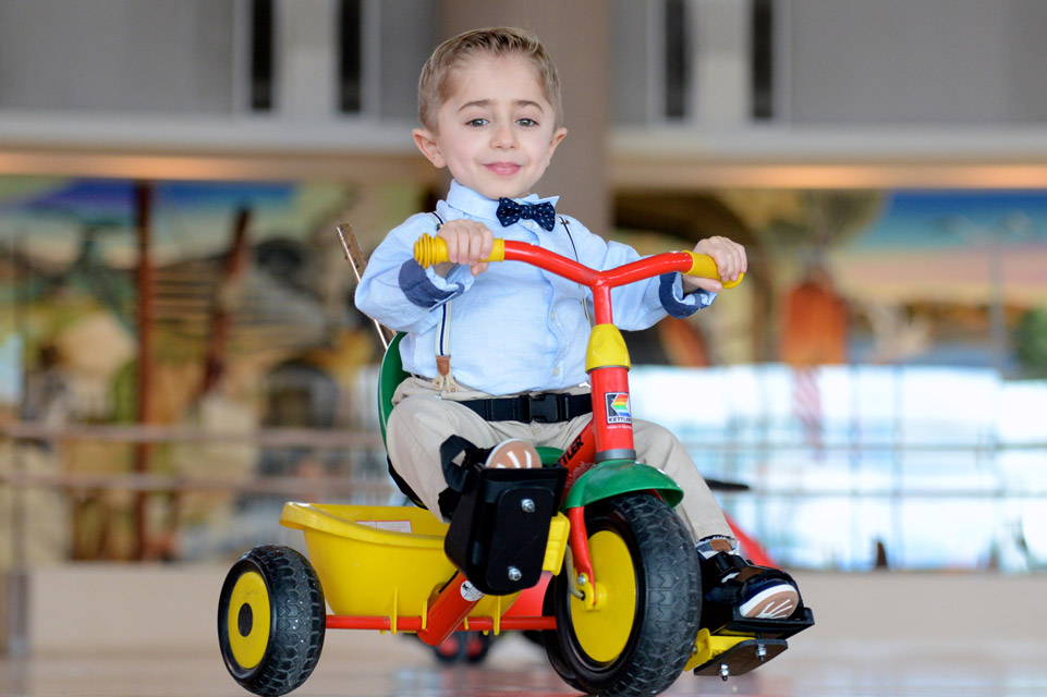 male patient riding tricycle