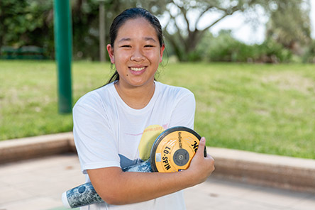female patient holding discus