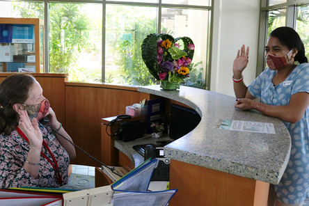 reception desk and two staff members