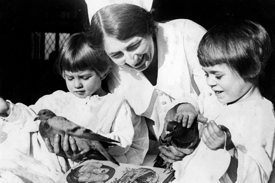 nurse with two patients holding birds