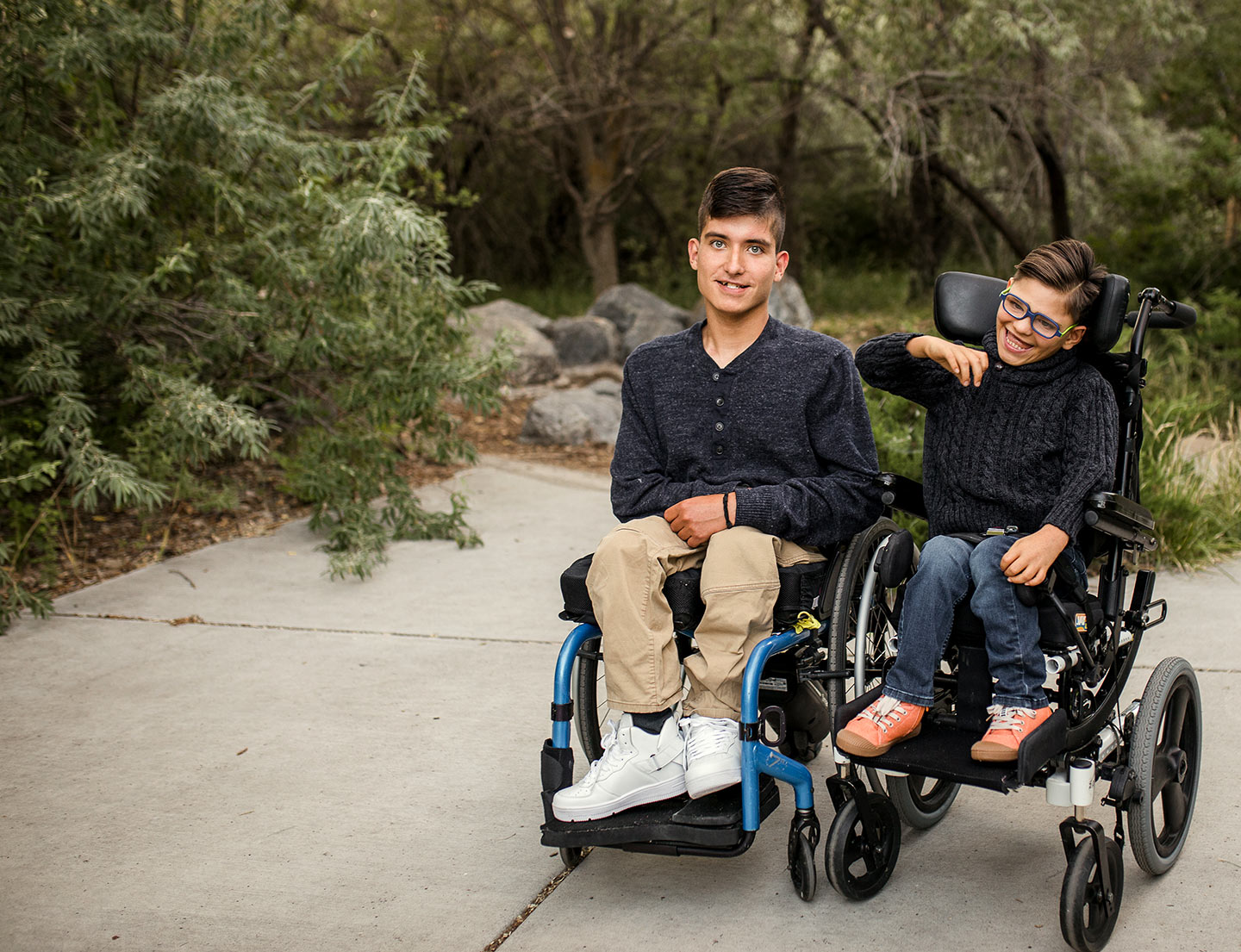 two male patients outside in wheelchairs