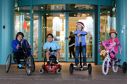 four patients on adaptive bikes