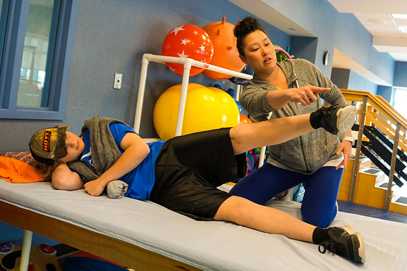 physical therapist working with patient