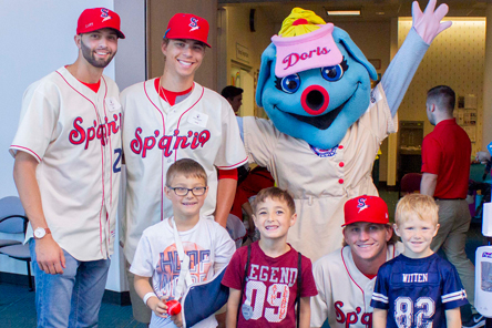 patient with friends, baseball players and mascot