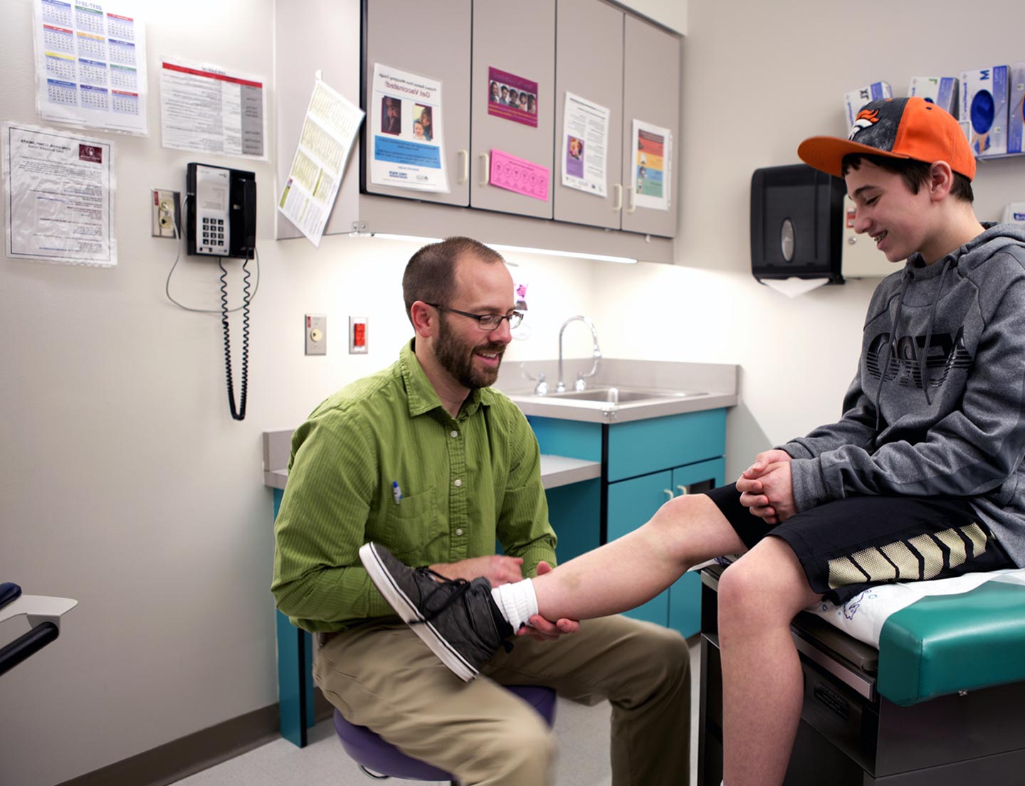 physician examining patient leg