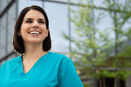 female nurse outside, smiling