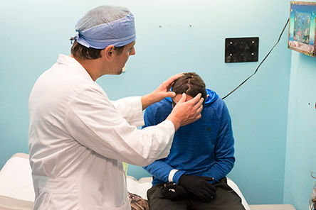 physician examining male patient