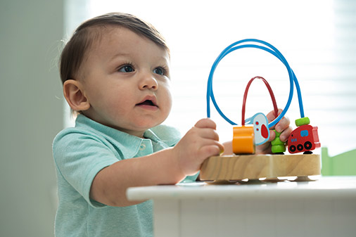 male toddler playing with child's toy