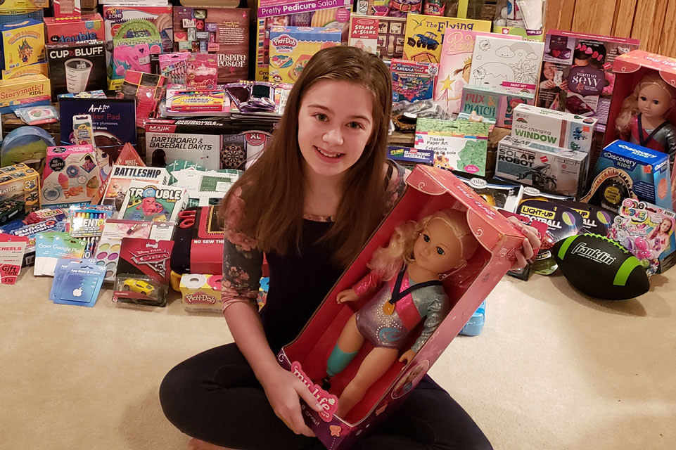 patient in front of several donated toys