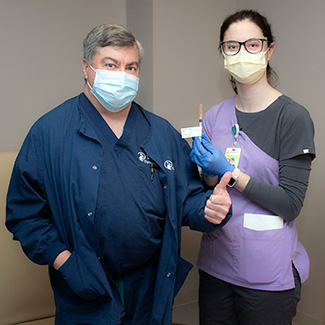 Doctor Mooney with staff member
