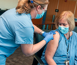 Staff member receiving vaccine