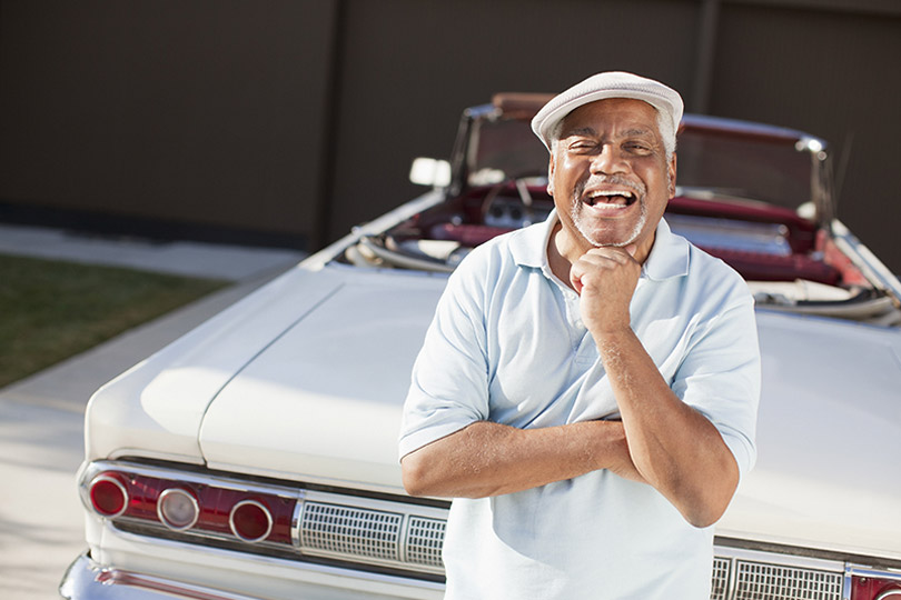 man in front of convertible automobile