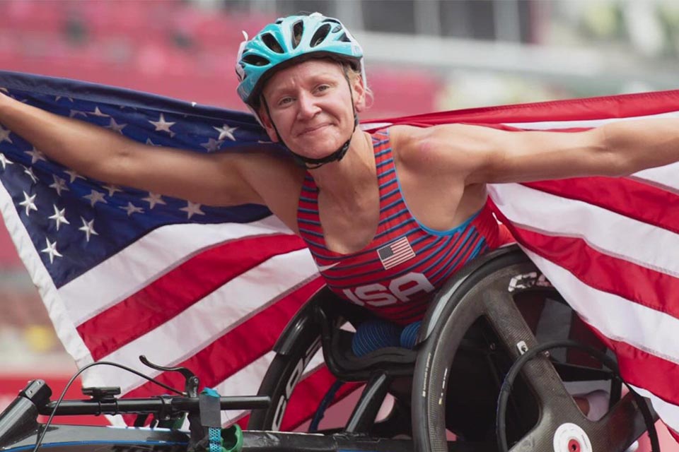 Susannah at paralympics holding American flag