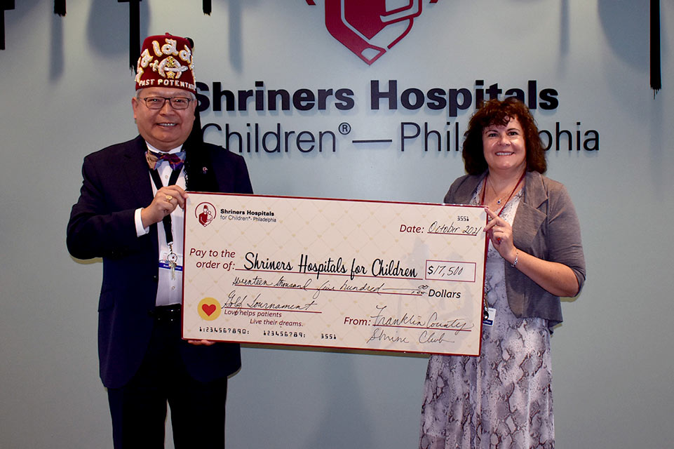 Terry and Shriner holding giant check