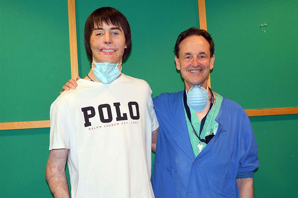 Dr. Sheridan standing next to patient Mykyta