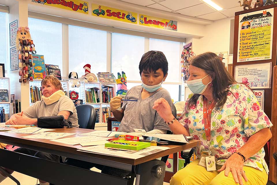 Teacher Sheryl Bucsanyi and a patient during school