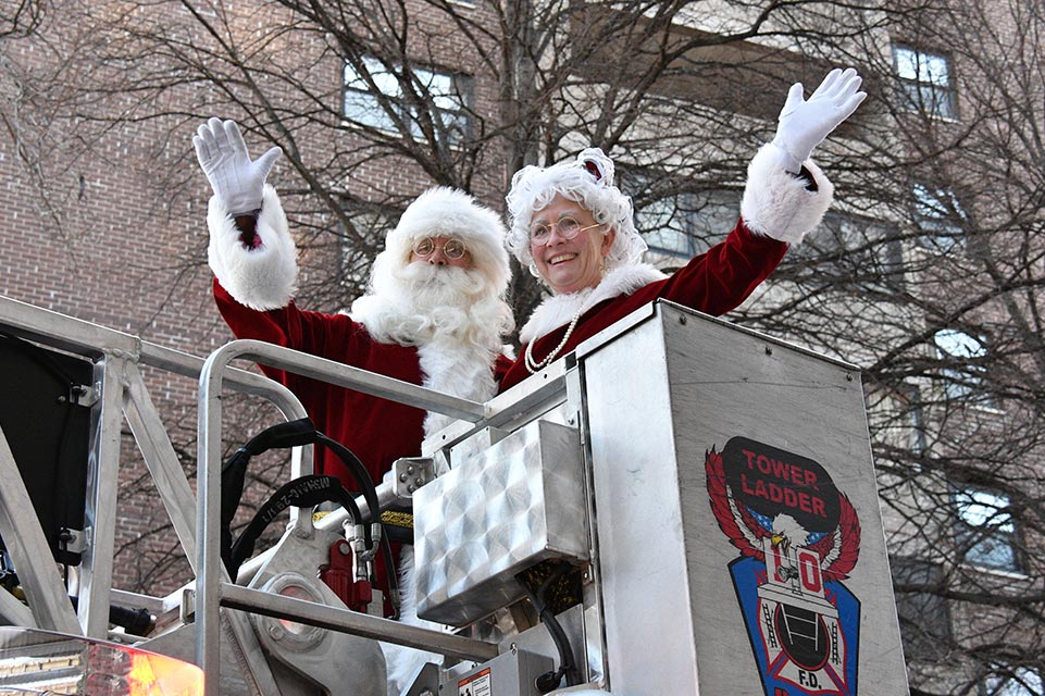 Santa and Mrs. Claus on a fire truck