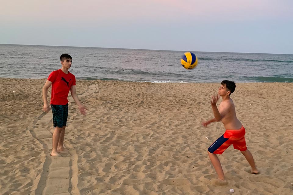 Victor playing on beach with his brother
