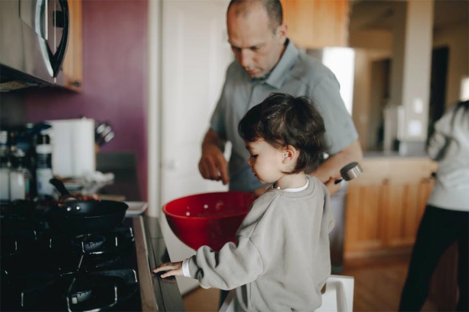 child cooking with parent