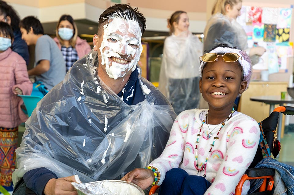 patient and firefighter with pie in face