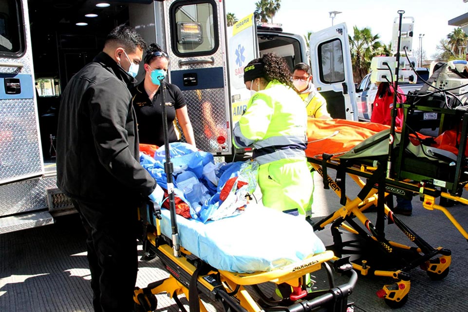 burn patient being loaded into ambulance by medical personnel
