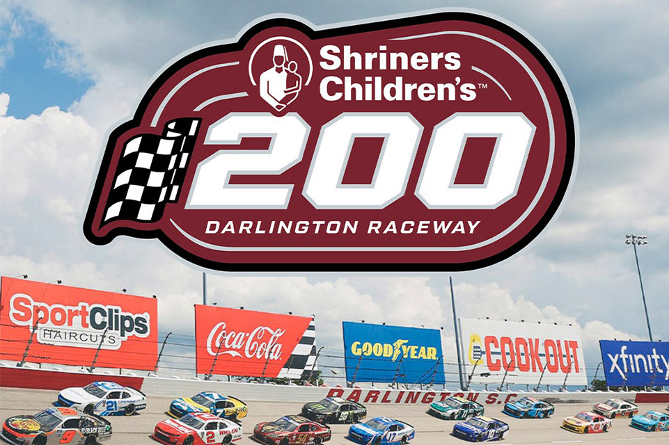 Shriners Children's 200 Darlington logo, ongoing race in background