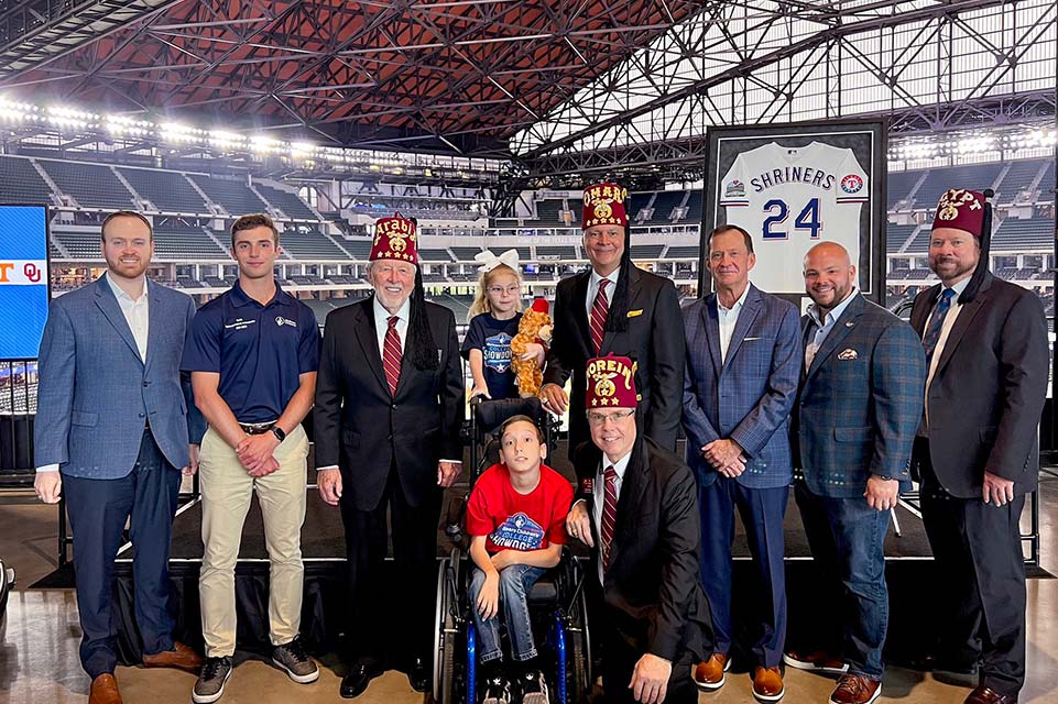 Shriner leaders and patients at stadium