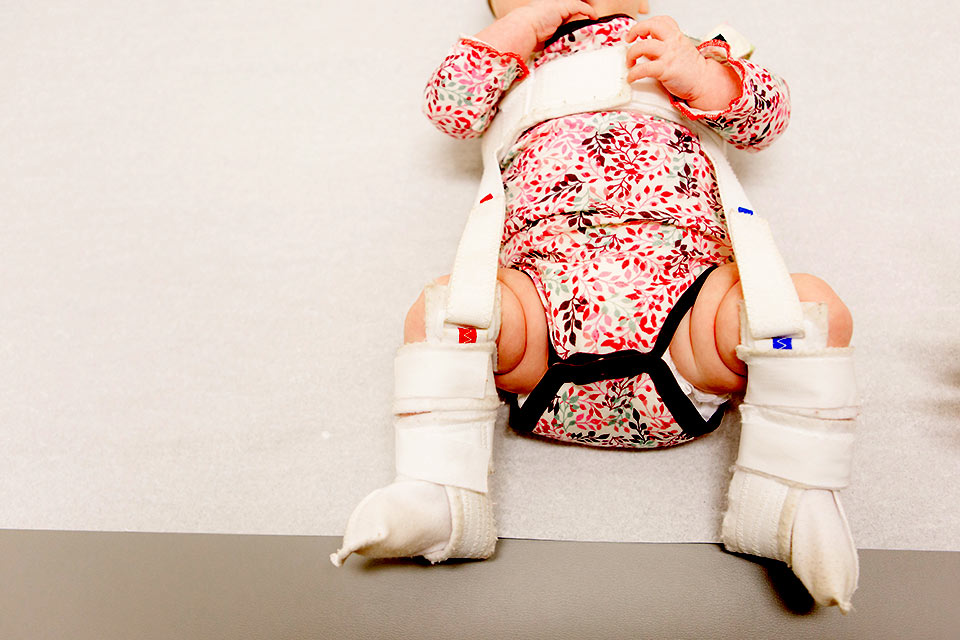 infant legs in harness