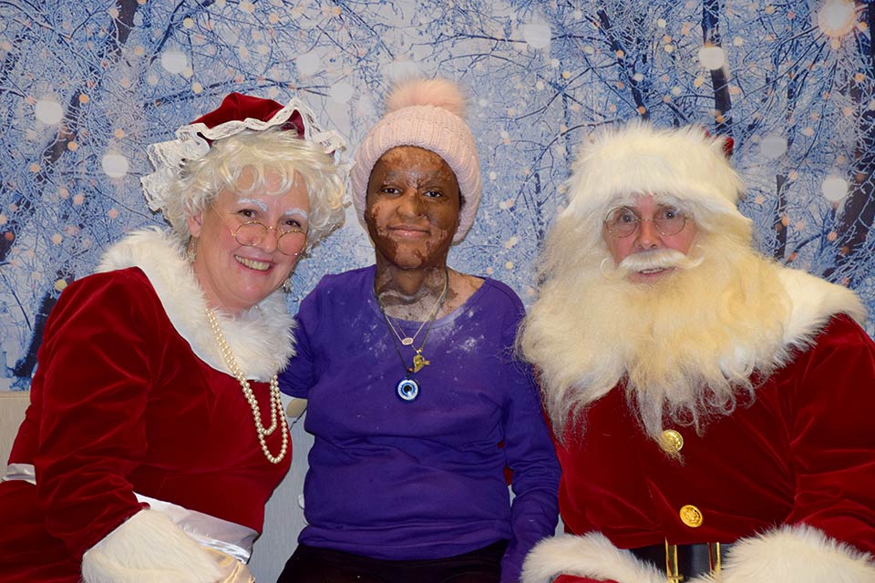 Santa and Mrs. Claus with burn patient