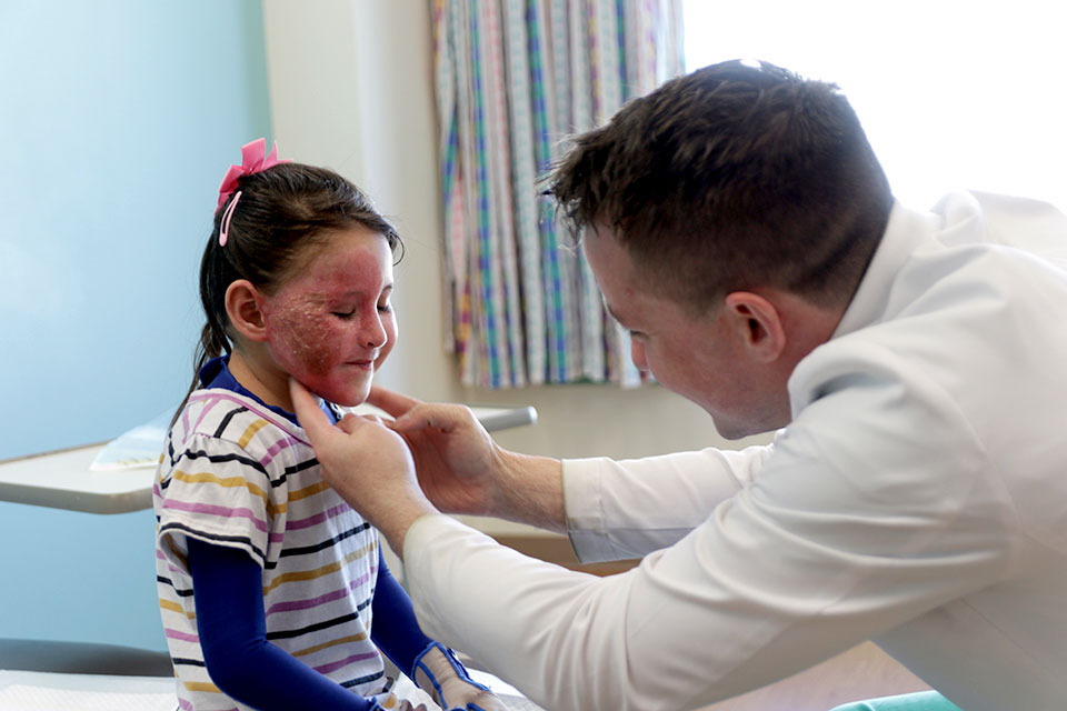 provider treating pediatric burn patient