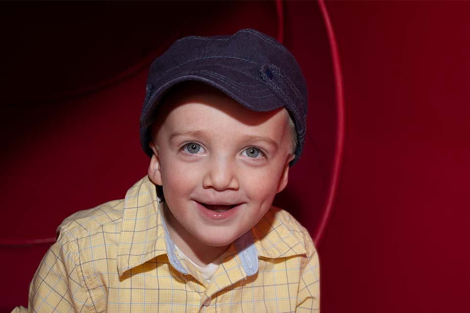 young boy with yellow shirt and blue hat