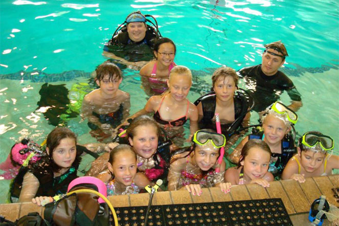 Elena giving scuba diving a try at Camp Achieve in 2009.