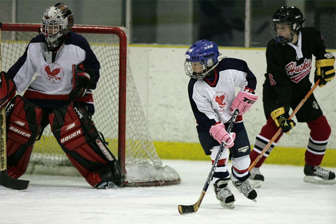 Elena playing hockey as a young girl