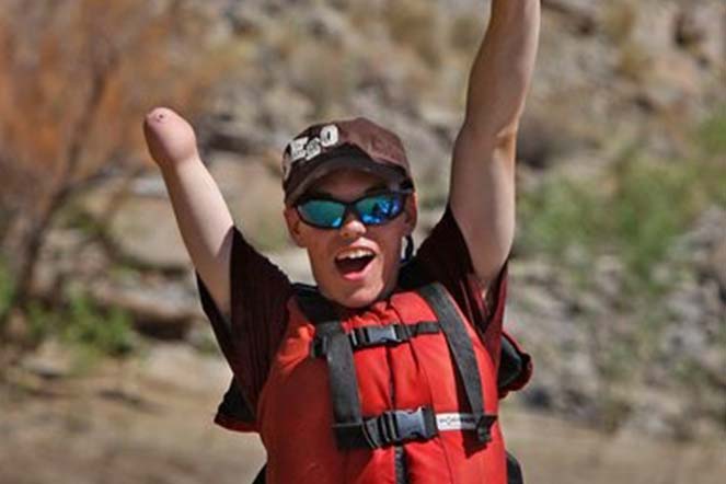 Lucas rafting and very happy with arms in the air