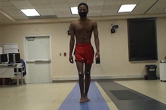 Yakobo walking on mat in motion analysis center years later