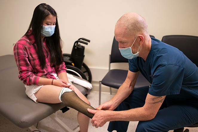 prosthetist Eric Smith working with Andie Sue