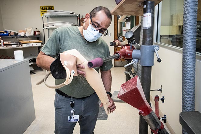prosthetist working on prosthetic arm
