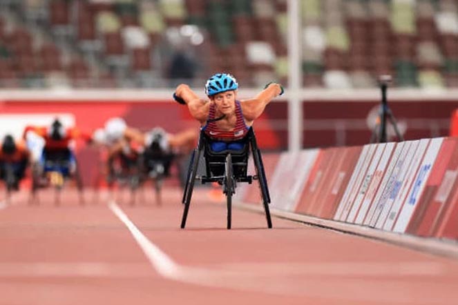 Susannah competing in wheelchair race at Paralympics