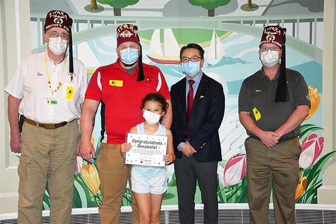 Annabelle with her father, grandfather, Shriner driver and Dr. Liao