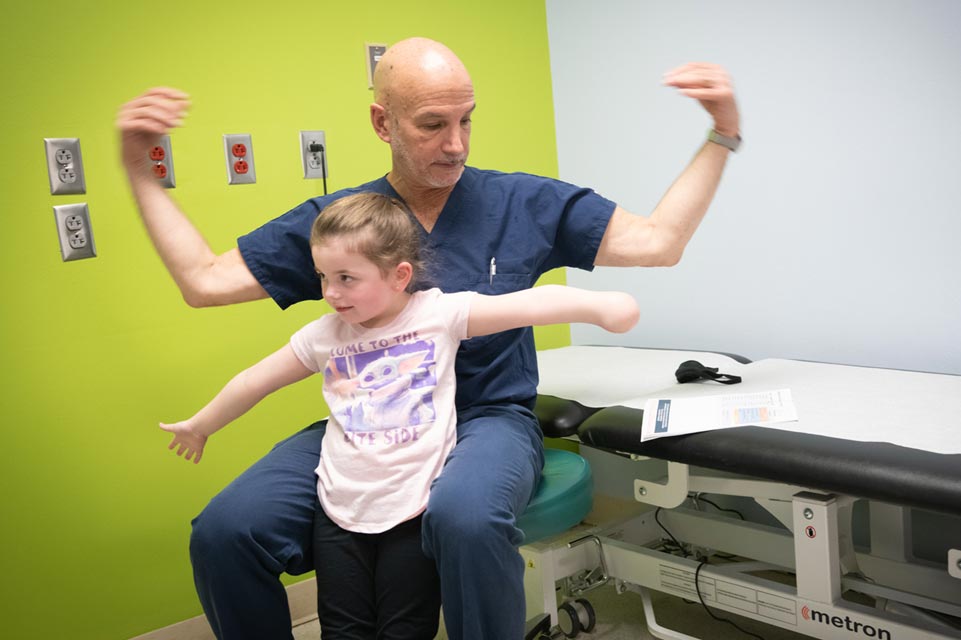 patient with doctor flexing