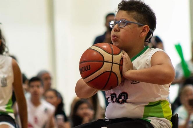 isaac playing basketball in a wheelchair
