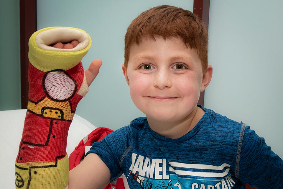 patient showing arm cast with special art