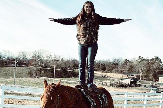 Madison standing on horse