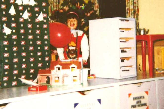 young Sarah surrounded by Christmas decorations