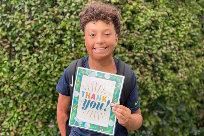 Bryson holding thank you card