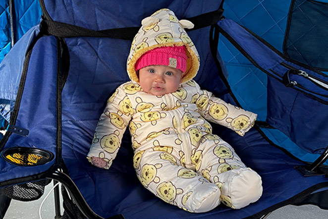 patient in snowsuit sitting in camping chair