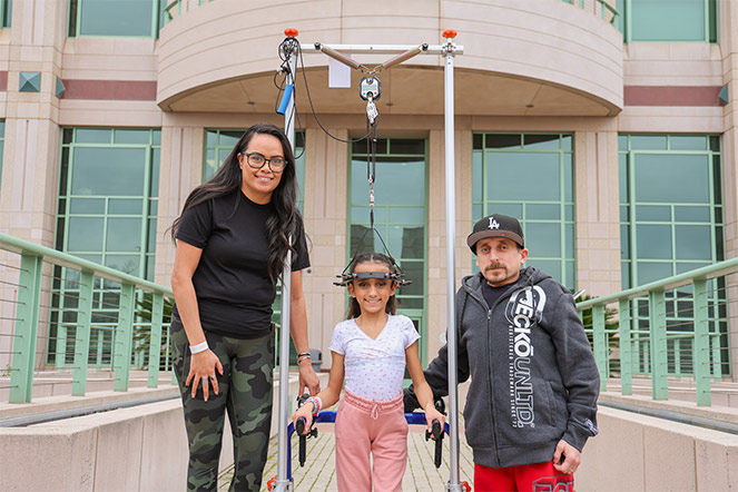 patient with halo traction standing next to parents